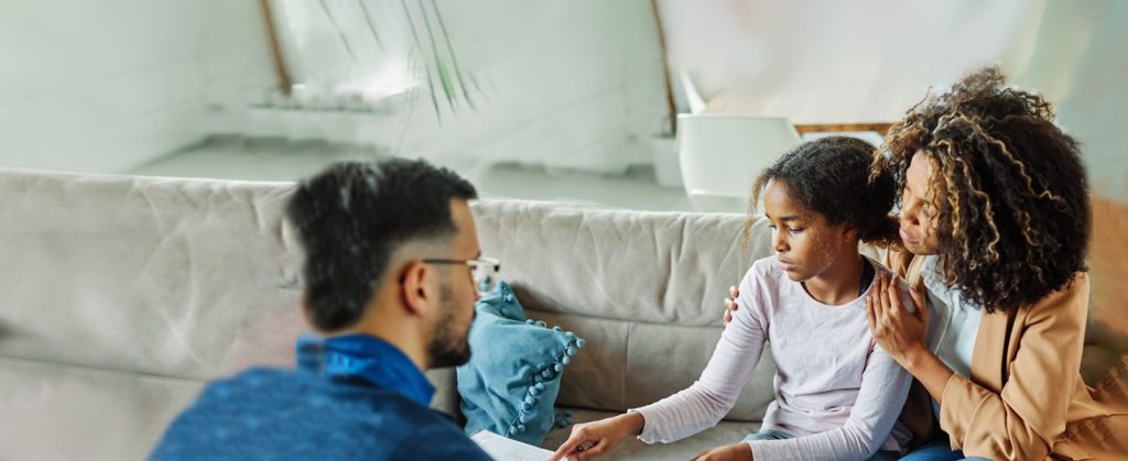 Mental Health First Aid: Mother holds daughter in counseling session