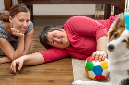 Texas Home Living Services: Attendant with woman with DD, both looking at the camera