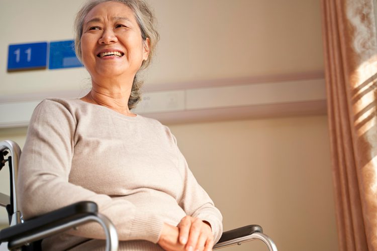 Community First Choice: Elderly woman smiling in a wheelchair