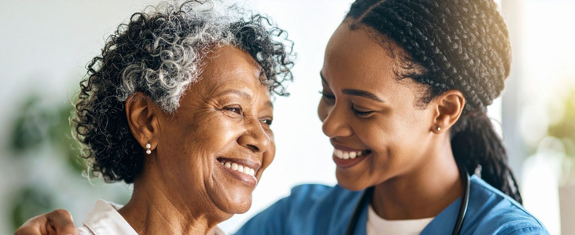 A nurse laughing with a patient.